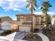 Beautifully landscaped home with a two-car garage, mature trees, and a welcoming walkway at 1661 Warrenville St, Las Vegas, NV 89117