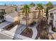 Well-maintained two-story home with attached garage, complemented by lush landscaping and palm trees at 1661 Warrenville St, Las Vegas, NV 89117