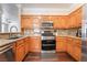 Spacious kitchen boasts granite countertops, stainless steel appliances, and wooden cabinetry at 1661 Warrenville St, Las Vegas, NV 89117