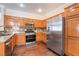 Well-equipped kitchen featuring stainless steel appliances and wood cabinets at 1661 Warrenville St, Las Vegas, NV 89117