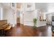 Spacious living area with wood floors, piano, fireplace, and staircase to the second floor at 1661 Warrenville St, Las Vegas, NV 89117