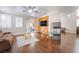 Open living room features hardwood floors, fireplace, and built-in media center with a ceiling fan at 1661 Warrenville St, Las Vegas, NV 89117
