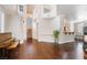 Spacious living area with wood floors, piano, fireplace, and staircase to the second floor at 1661 Warrenville St, Las Vegas, NV 89117
