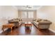 Comfortable living room with hardwood floors, ceiling fan, and shuttered windows for ample natural light at 1661 Warrenville St, Las Vegas, NV 89117
