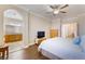 Open Primary bedroom leads to ensuite bath, wood floors, ceiling fan and TV at 1661 Warrenville St, Las Vegas, NV 89117