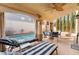 Covered patio includes lounge chairs and an outdoor dining set near the pool at 1661 Warrenville St, Las Vegas, NV 89117