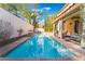Backyard features a private pool and spa with a covered patio and landscaping at 1661 Warrenville St, Las Vegas, NV 89117