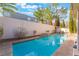 Backyard features a private pool and spa with lush landscaping and privacy wall at 1661 Warrenville St, Las Vegas, NV 89117