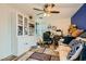 Office space with built-in shelving, a ceiling fan, and a large window at 208 Summit Creek Ave, North Las Vegas, NV 89031