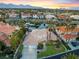 Stunning aerial view of a luxury home featuring a sparkling pool, mature landscaping, and a tranquil lake at 2221 Glenbrook Way, Las Vegas, NV 89117