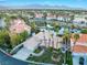 Aerial view of home featuring lush landscaping, driveway, and partial water view at 2221 Glenbrook Way, Las Vegas, NV 89117