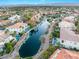 Panoramic aerial view of a community with a scenic pond, lush landscaping, and attractive homes at 2221 Glenbrook Way, Las Vegas, NV 89117