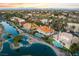 Picturesque aerial view of a neighborhood showcasing beautiful homes, lush landscaping, and serene waterways at 2221 Glenbrook Way, Las Vegas, NV 89117