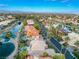 Panoramic aerial view showcasing a residential neighborhood with lake, lush greenery, and mountain views at 2221 Glenbrook Way, Las Vegas, NV 89117
