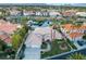 Aerial view of single-Gathering home with well-manicured lawn and lush landscaping with community lake at 2221 Glenbrook Way, Las Vegas, NV 89117