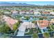 Aerial view of residential area featuring a lake with beautiful homes and lush landscaping and mountains at 2221 Glenbrook Way, Las Vegas, NV 89117