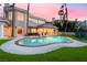 Backyard showcasing a pool, spa, and manicured lawn, perfect for outdoor enjoyment at sunset at 2221 Glenbrook Way, Las Vegas, NV 89117