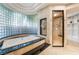 Luxurious bathroom boasting a jetted tub, separate shower, and stylish tile work, creating a spa-like experience at home at 2221 Glenbrook Way, Las Vegas, NV 89117