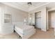 Well-lit bedroom with white minimalist furniture, a ceiling fan, and a mirrored closet door at 2221 Glenbrook Way, Las Vegas, NV 89117