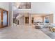 Open-concept floor plan showcases travertine floors, spiral staircase, and elegant living and dining spaces at 2221 Glenbrook Way, Las Vegas, NV 89117