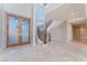 Elegant foyer with decorative double doors, curved staircase, and travertine floors, setting a grand entrance at 2221 Glenbrook Way, Las Vegas, NV 89117