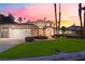 Attractive home with a lush green lawn, mature trees, and a spacious three-car garage at 2221 Glenbrook Way, Las Vegas, NV 89117