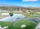 Stunning aerial view of golf course with pristine greens and a picturesque pond at 2221 Glenbrook Way, Las Vegas, NV 89117