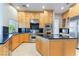 Kitchen features stainless steel appliances, granite countertops, a kitchen island and custom cabinets at 2221 Glenbrook Way, Las Vegas, NV 89117