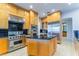 Kitchen features stainless steel appliances, granite countertops, a kitchen island and custom cabinets at 2221 Glenbrook Way, Las Vegas, NV 89117