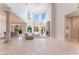 Open-concept living space with large windows, fireplace, and travertine flooring at 2221 Glenbrook Way, Las Vegas, NV 89117