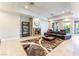 Spacious living area with fireplace, tile floors, and sliding glass doors to the backyard at 2221 Glenbrook Way, Las Vegas, NV 89117