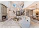 Cozy living room with fireplace, grand chandelier, and an elegant winding staircase at 2221 Glenbrook Way, Las Vegas, NV 89117