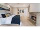 Well-lit main bedroom with a fireplace, tile floors, and contemporary decor, offering a stylish and cozy atmosphere at 2221 Glenbrook Way, Las Vegas, NV 89117
