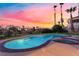 Swimming pool and spa with lush landscaping and neighborhood views at sunset at 2221 Glenbrook Way, Las Vegas, NV 89117