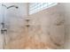 Tiled shower with a shower head, a glass block window, and a built in shelf at 2221 Glenbrook Way, Las Vegas, NV 89117