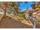 Expansive backyard featuring mature trees, desert landscaping and a covered patio perfect for entertaining at 2611 Laguna Shores Ln, Las Vegas, NV 89121