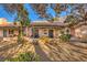 Charming backyard featuring a patio, lush greenery, and a well-maintained landscape at 2611 Laguna Shores Ln, Las Vegas, NV 89121