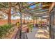 Relaxing backyard patio area with lush landscaping, seating, and shaded cover at 2611 Laguna Shores Ln, Las Vegas, NV 89121