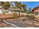 A spacious backyard showcases desert landscaping and a concrete perimeter, ensuring both beauty and easy maintenance at 2611 Laguna Shores Ln, Las Vegas, NV 89121