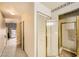 Hallway with view of glass-enclosed shower and exterior door at 2611 Laguna Shores Ln, Las Vegas, NV 89121