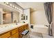 Bathroom featuring double sinks, a soaking tub, and modern fixtures at 2611 Laguna Shores Ln, Las Vegas, NV 89121