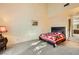 Bright bedroom featuring high ceilings, a cozy quilt, and an ensuite bathroom at 2611 Laguna Shores Ln, Las Vegas, NV 89121