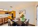 Cozy dining area next to kitchen with seating for four; features wood flooring and backyard view at 2611 Laguna Shores Ln, Las Vegas, NV 89121