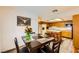 Open concept dining area and kitchen featuring wood cabinets, stainless steel appliances, and island seating at 2611 Laguna Shores Ln, Las Vegas, NV 89121