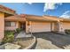 Charming townhome with attached garage, walkway, and well-maintained landscaping that provides curb appeal at 2611 Laguna Shores Ln, Las Vegas, NV 89121
