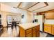 Spacious kitchen features wood cabinets, a kitchen island, and a dining area with French doors to the backyard at 2611 Laguna Shores Ln, Las Vegas, NV 89121