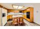Classic kitchen features wood cabinets, matching island with breakfast bar, and stainless steel appliances at 2611 Laguna Shores Ln, Las Vegas, NV 89121