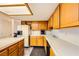 Spacious kitchen features wood cabinets, white countertops, a kitchen island, and modern appliances at 2611 Laguna Shores Ln, Las Vegas, NV 89121