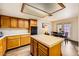Charming kitchen features wood cabinets, tile countertops, island and a dining area with French doors at 2611 Laguna Shores Ln, Las Vegas, NV 89121