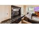 Living room featuring a decorative black marble fireplace and wood flooring at 2611 Laguna Shores Ln, Las Vegas, NV 89121